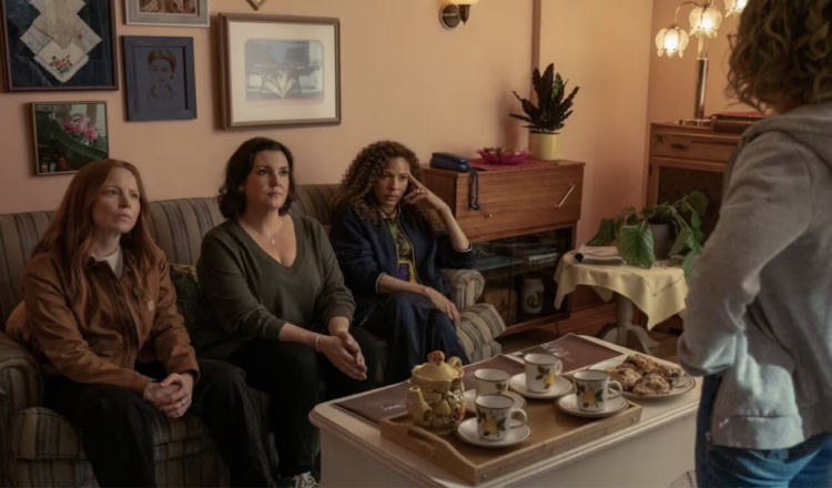 Scene from season 3 of yellowjackets with the adult women together in a living room
